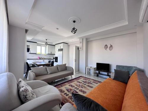a living room with two couches and a dining room at Lavender Villas in Dalaman