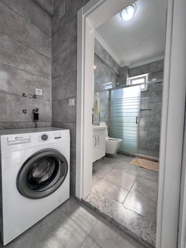 a washing machine in a bathroom with a shower at Lavender Villas in Dalaman