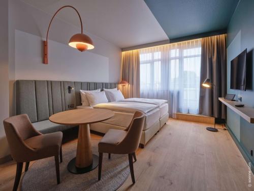 Ένα ή περισσότερα κρεβάτια σε δωμάτιο στο Dorint Hotel Bonn