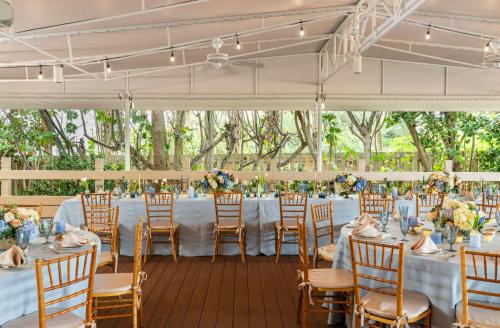 a wedding reception in a marquee with tables and chairs at The Singer Oceanfront Resort, Curio Collection by Hilton in Palm Beach Shores