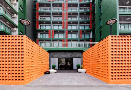 an orange fence in front of a building at SureStay By Best Western Iconic Suvarnabhumi in Samut Prakan