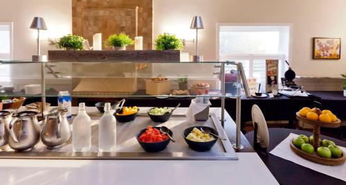 a buffet line with bowls of fruit on a table at Elm Hurst Inn & Spa in Ingersoll