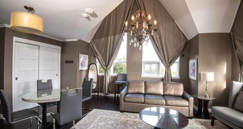 a living room with a couch and a table at Elm Hurst Inn & Spa in Ingersoll