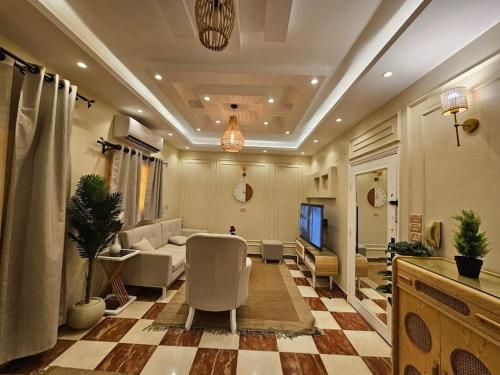a large living room with a couch and a table at Mansoura's sweet home hotel appartment 3 in Bandar al Manşūrah