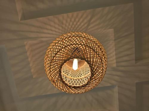 a wicker chandelier hanging from a ceiling at Mansoura's sweet home hotel appartment 3 in Bandar al Manşūrah