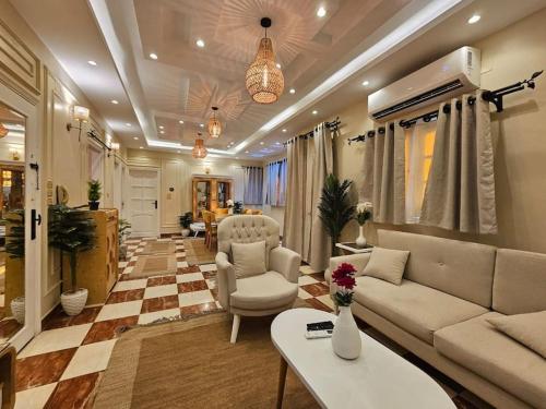 a living room with a couch and a table at Mansoura's sweet home hotel appartment 3 in Bandar al Manşūrah