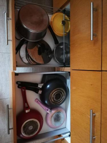 a cupboard filled with lots of pots and pans at Hua Hin Blue Lagoon in Cha Am