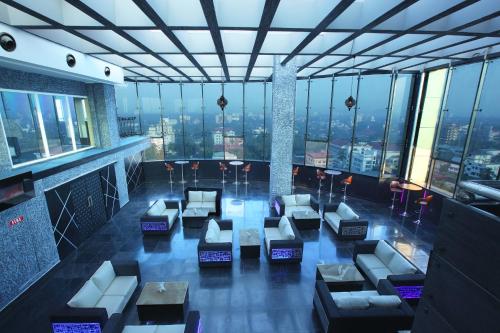 a room with couches and tables in a building at The Garuda Hotels in Trichūr