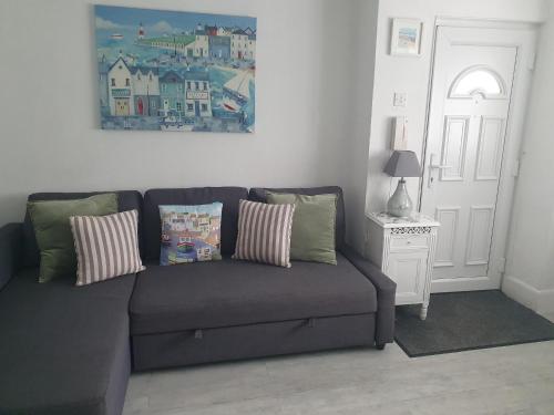 a couch in a living room with a painting on the wall at Great for town & beach in Bournemouth