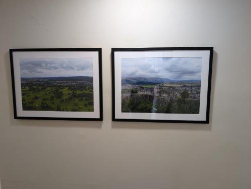 three framed photographs on a white wall at 19 Snowdon Apartment in Stirling