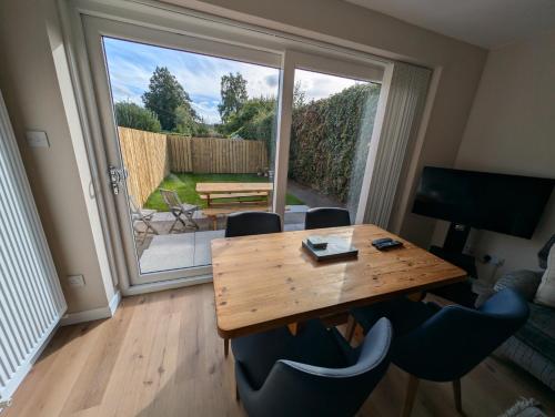 a dining room with a table and chairs and a large window at 19 Snowdon Apartment in Stirling