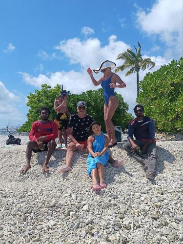 a group of people sitting on the beach at Rindali - The speedboat from Malé to the hotel departs at 1130 every Monday Thursday and Saturday and from the hotel to Malé at 0630 and five domestic flights are available every day in Dhaalu Atoll