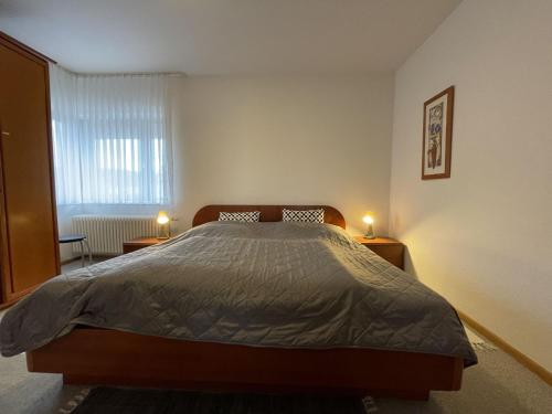 a bedroom with a bed and two lights on tables at Apartment Schwarzwaldblick-27 by Interhome in Obertal