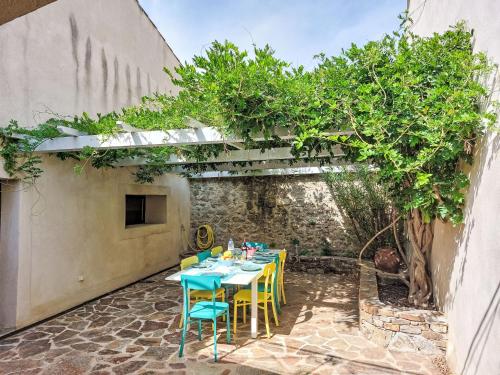 d'une terrasse avec une table, des chaises et un arbre. dans l'établissement Holiday Home La Petite Occitane by Interhome, à Emponse