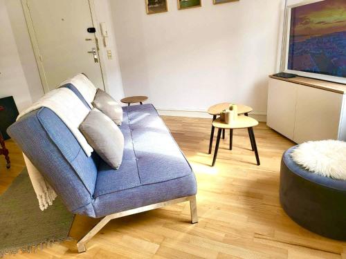 a living room with a blue couch and a table at aday - Superb cozy apartment in Vejle in Vejle