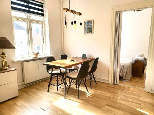 a dining room with a wooden table and chairs at aday - Superb cozy apartment in Vejle in Vejle