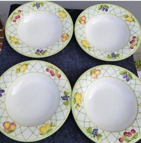 four plates with flowers on them sitting on a table at Hua Hin Blue Lagoon in Cha Am