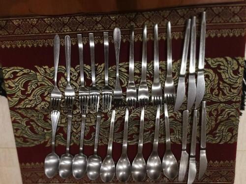 a group of forks and spoons hanging on a wall at Hua Hin Blue Lagoon in Cha Am