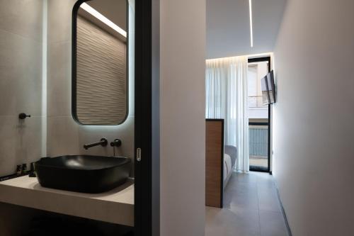 a bathroom with a black sink on a counter at Nema Hotel Athens in Athens