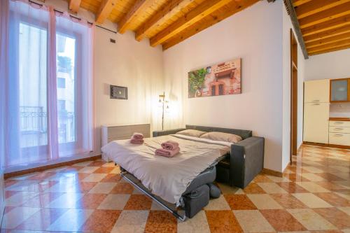 a bedroom with two beds and a large window at HISTORIC CENTER VIEW-2 minutes from Arena & Juliet's house- Mazzini Palace in Verona