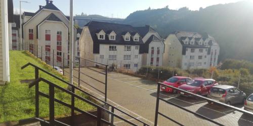 a parking lot with cars parked in front of buildings at Puerto Montt Departamentos in Puerto Montt