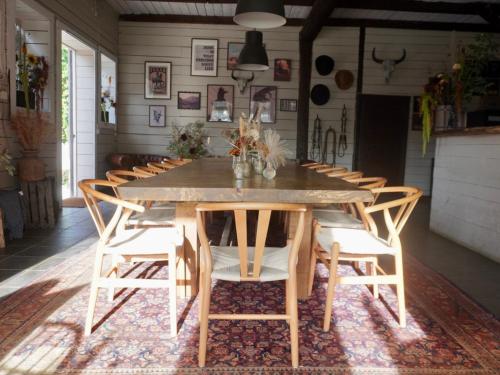 a dining room with a large wooden table and chairs at Long Valley Ranch & Lodge in Nykvarn