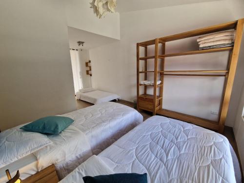 a bedroom with two beds and a bunk bed at Hotel La Caracola Salento in Salento