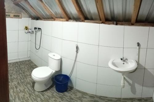 a bathroom with a toilet and a sink at Senaru sunset house in Senaru