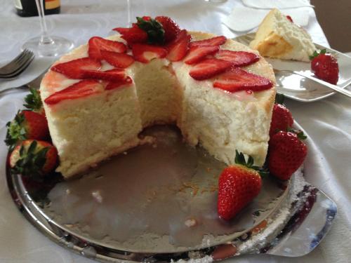 a piece of cake with strawberries on a plate at B&B Il Piccolo Principe room and breakfast in Bieno