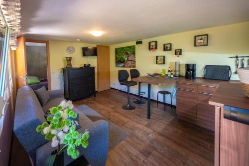 a living room with a couch and a table at Ferienbungalow Poppengrün in Poppengrün