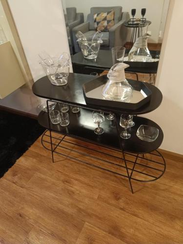 a black coffee table with glasses on top of it at H4 La Residence Paulista in Sao Paulo