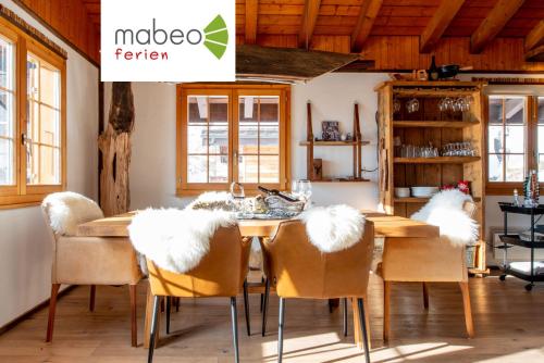 a dining room with a wooden table and chairs at Chalet Bijou in Blitzingen