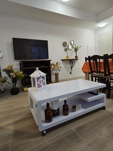 a living room with a white table with bottles on it at New Living Milano in Gorgonzola