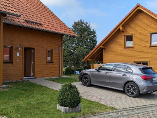 a silver car parked in front of a house at Ferienhaus Ostara in Hasselfelde