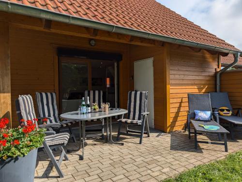 a patio with chairs and a table in front of a building at Ferienhaus Ostara in Hasselfelde