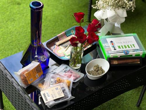 a table with a tray of food and flowers on it at Smokers Resort in Pattaya South