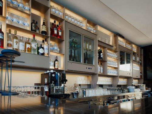 a bar with bottles of alcohol on the wall at Casa 300Mila in Lecce