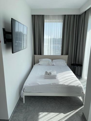 a bedroom with a bed with two towels on it at Wilanów Residence Apartments in Warsaw