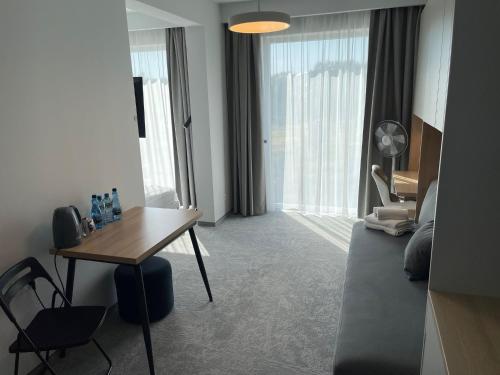 a room with a desk and a table and a couch at Wilanów Residence Apartments in Warsaw