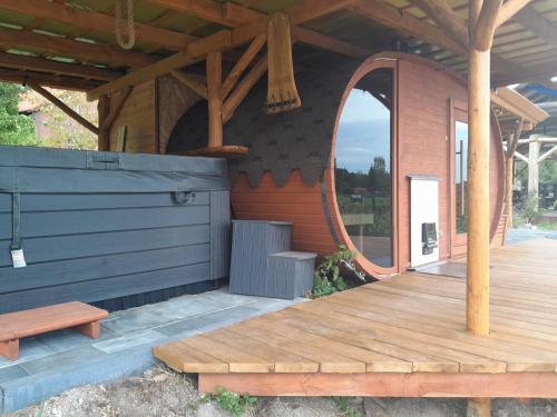 a porch of a cabin with a wooden deck at Holender Przy Plaży in Wilimy