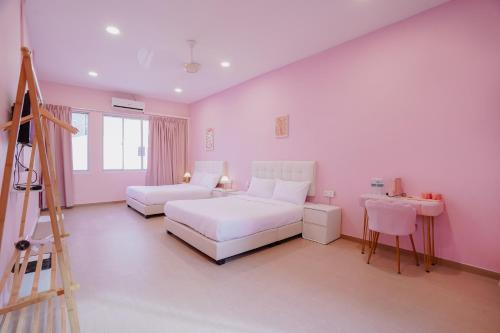 a pink bedroom with a bed and a ladder at Pink Cabana Hotel in George Town