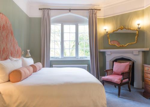 a bedroom with a bed and a chair and a window at Burley Manor in Burley