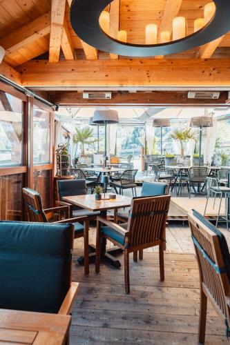 a restaurant with wooden ceilings and tables and chairs at Schindler in Sankt Anton am Arlberg