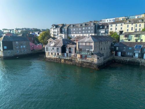 a group of buildings next to a body of water at Janes Court, Packet Quays in Falmouth