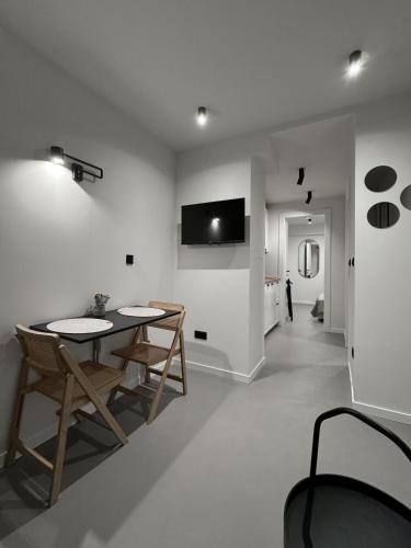 a white living room with a table and chairs at PaMar Downtown Apartments in Split
