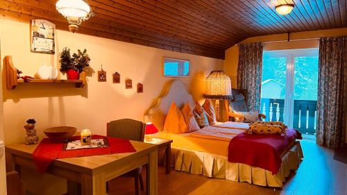 a bedroom with a bed and a table in it at Appartement Christina in Bad Kleinkirchheim