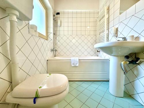 a bathroom with a toilet and a sink at Little Loft in Timişoara