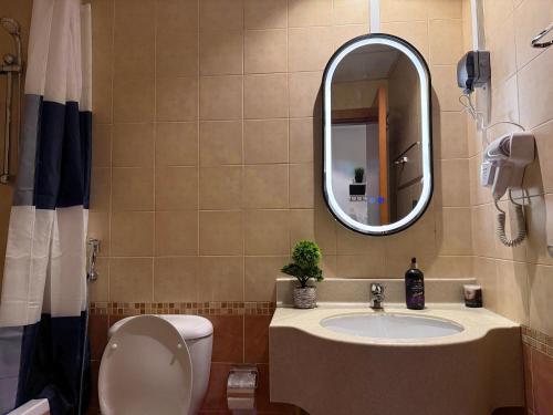 a bathroom with a sink and a toilet and a mirror at Livincci - Luxury Studio in Dubai Marina - 15 in Dubai