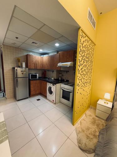 a kitchen with a stove and a refrigerator at Livincci - Luxury Studio in Dubai Marina - 15 in Dubai