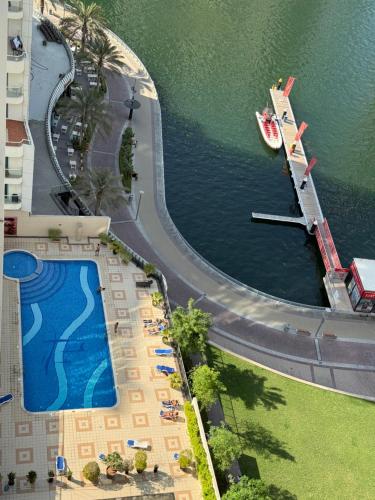 an aerial view of a resort with a boat in the water at Livincci - Luxury Studio in Dubai Marina - 15 in Dubai